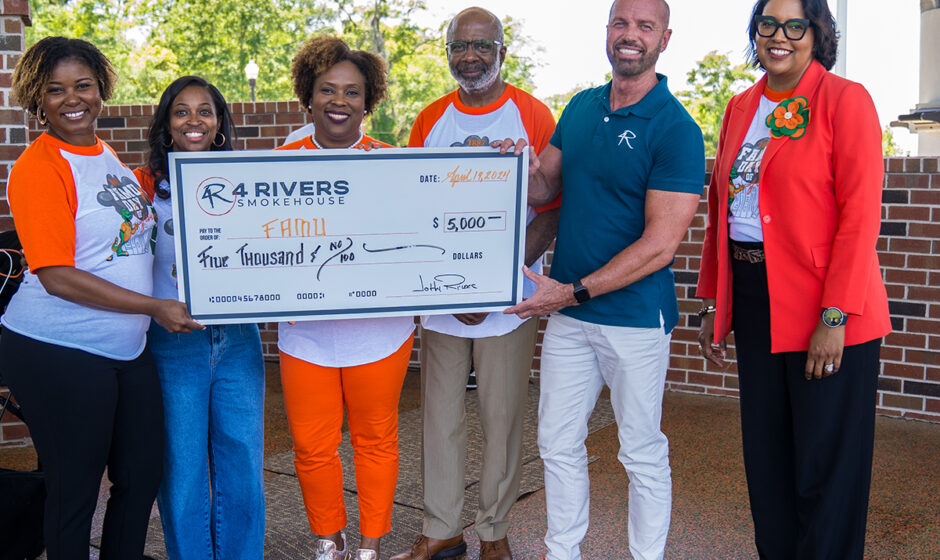 President Robinson, Provost Watson and University Advancement staff accept check from 4 Rivers Barbecue (Credit: Christian Whitaker)