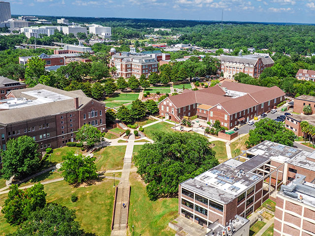 Aerial view of campus with view of downtown